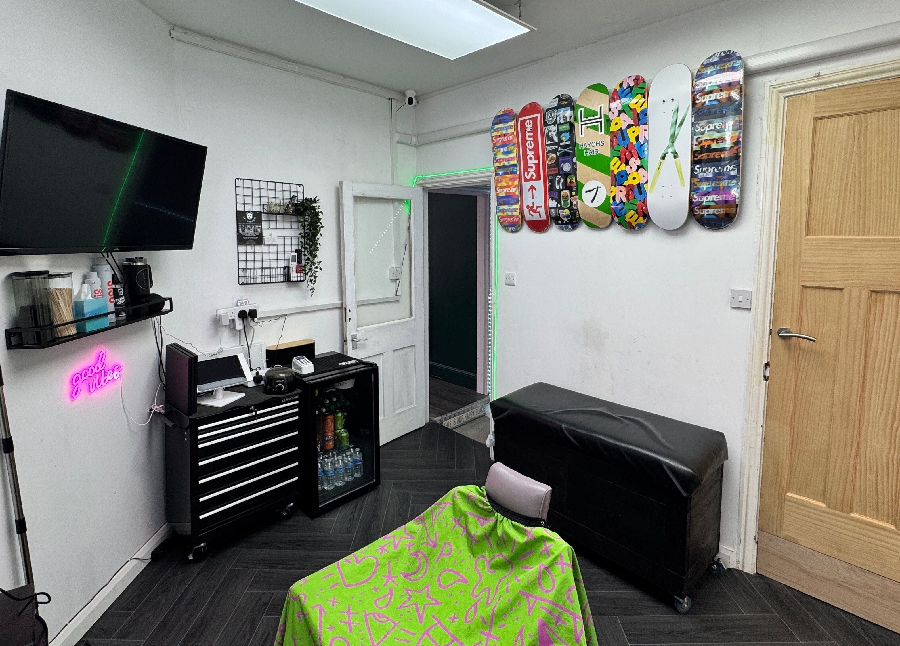 Modern interior of Haychs Hair Barbershop in Horsham, England, GB with colorful decor and sleek furniture.