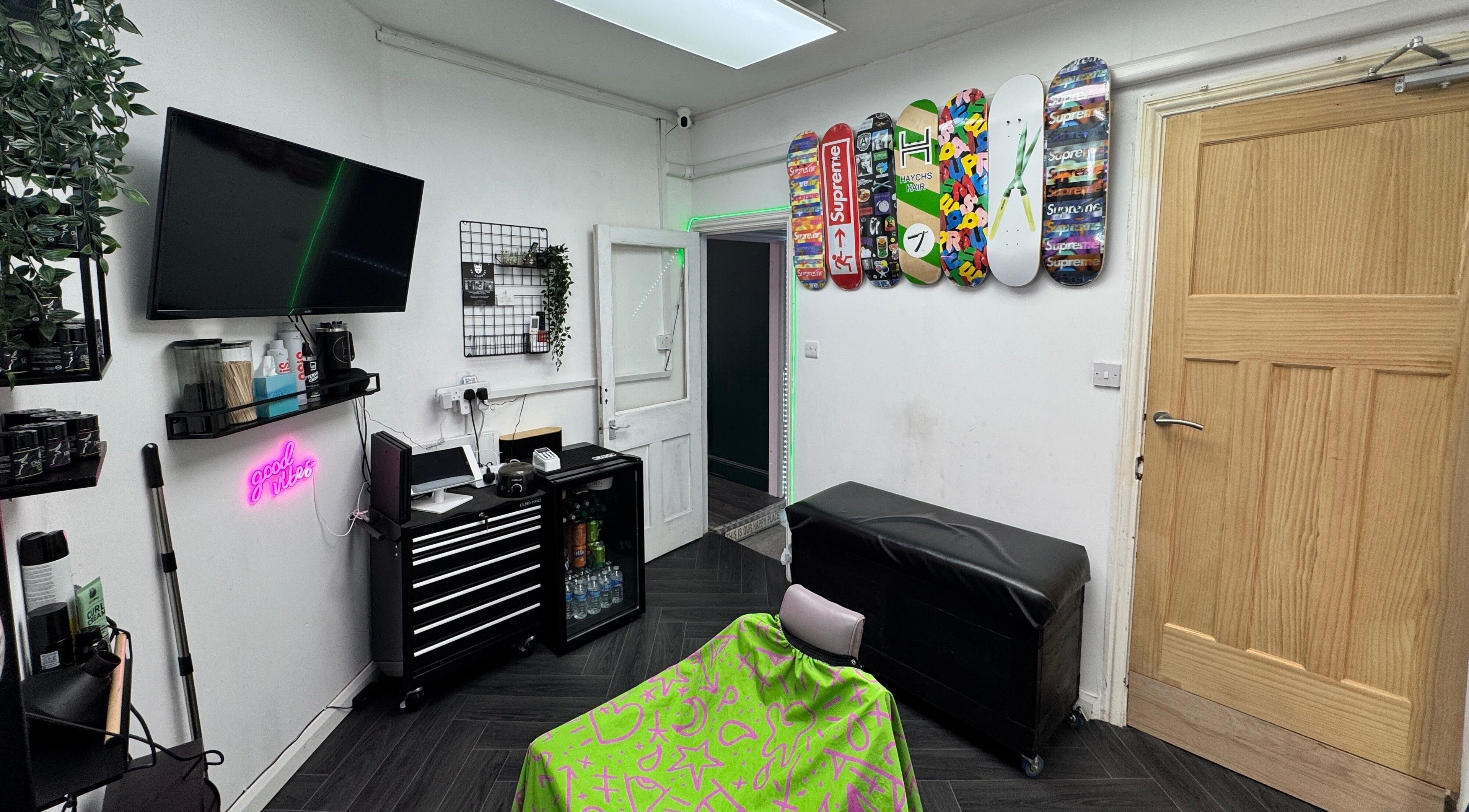 Modern interior of Haychs Hair Barbershop in Horsham, England, GB with colorful decor and sleek furniture.