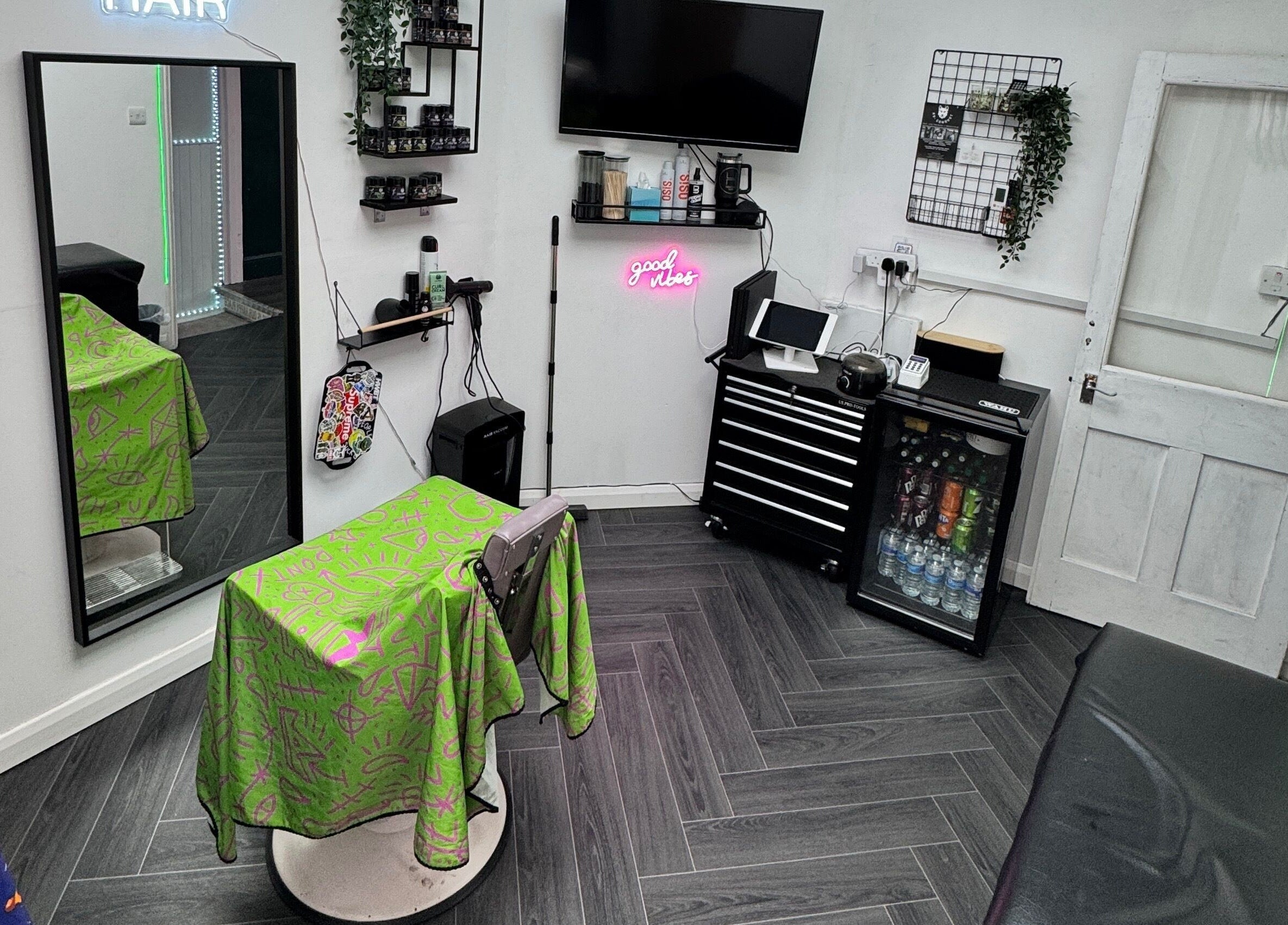 Modern interior of Haychs Hair Barbershop, Horsham, England showcasing styling chair and neon sign.