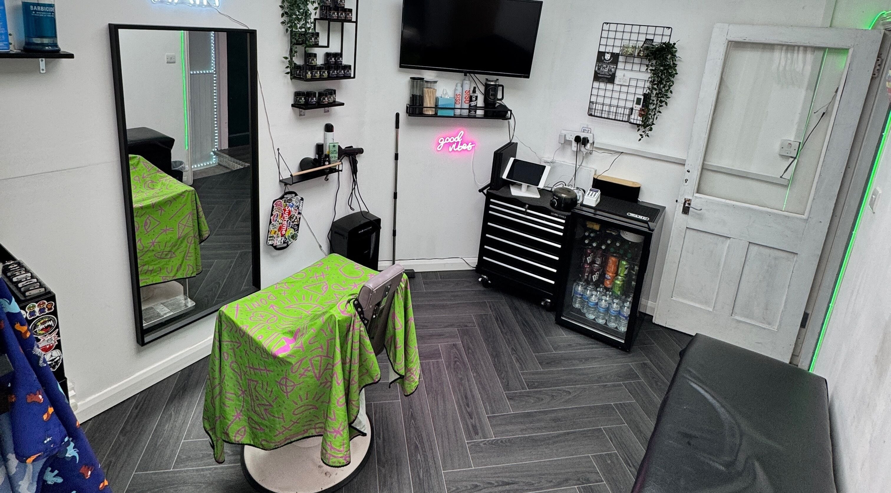 Modern interior of Haychs Hair Barbershop, Horsham, England showcasing styling chair and neon sign.