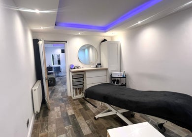 Relaxing treatment room at The Beauty Stop, Edinburgh, Scotland, GB, featuring a massage bed and calming decor.