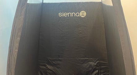 Sienna X tanning booth at The Beauty Stop, Edinburgh, Scotland, GB, offering professional spray tanning.