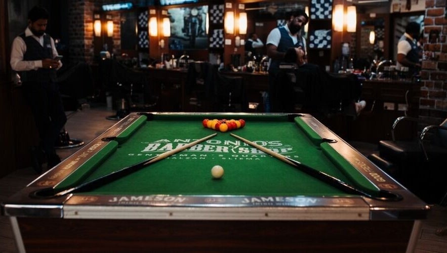 Billiards table inside Antonio's Barbershop Balzan, Ħal Balzan, MT, showcasing unique ambiance.