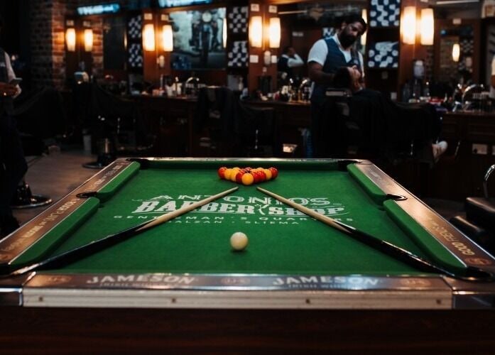 Billiards table inside Antonio's Barbershop Balzan, Ħal Balzan, MT, showcasing unique ambiance.