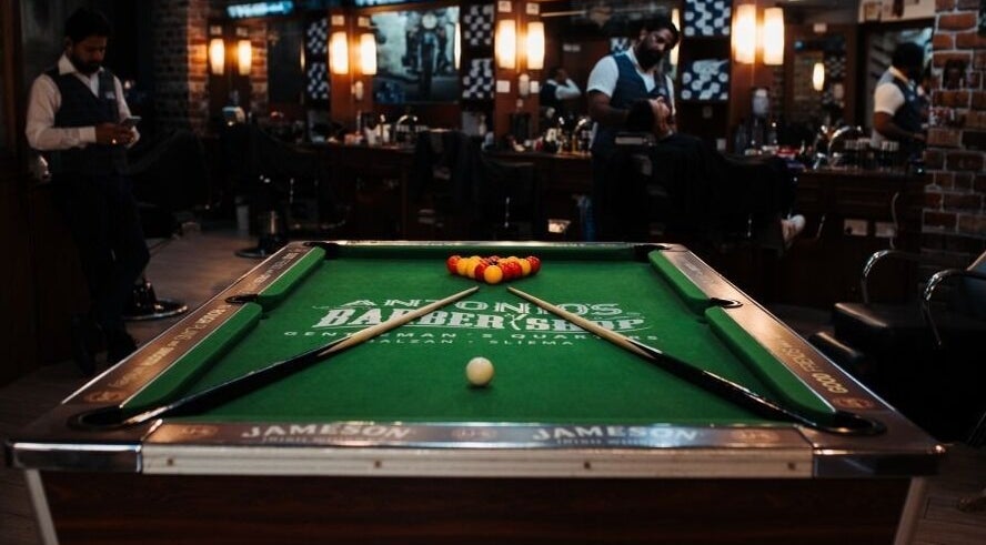 Billiards table inside Antonio's Barbershop Balzan, Ħal Balzan, MT, showcasing unique ambiance.