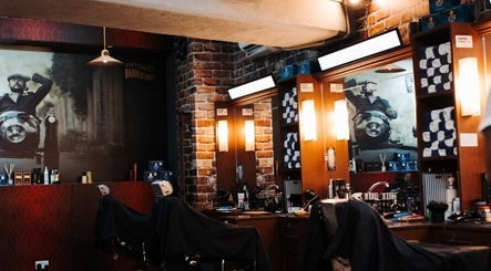 Inside Antonio's Barbershop Balzan, warm lighting and vintage decor create a welcoming ambiance in Ħal Balzan, MT.