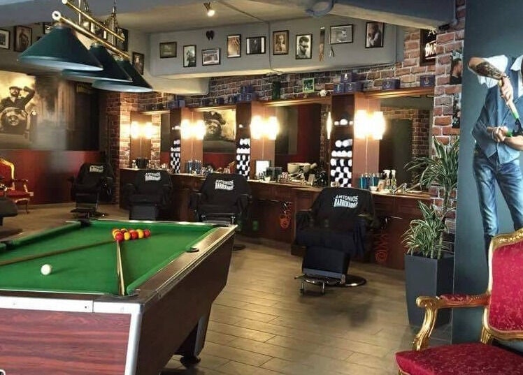 Interior of Antonio's Barbershop Balzan in Ħal Balzan, MT, featuring a pool table and vintage decor.