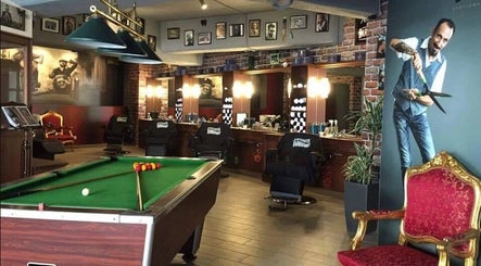 Interior of Antonio's Barbershop Balzan in Ħal Balzan, MT, featuring a pool table and vintage decor.