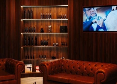 Elegant lounge at Antonio's Signature Mriehel in Birkirkara, MT, featuring leather seating and shelving.