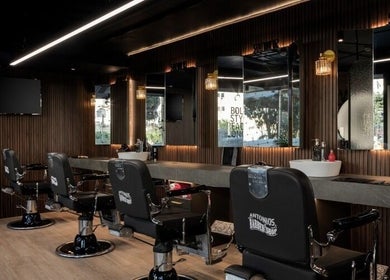 Modern interior of Antonio's Barbershop Spinola Park, San Ġiljan, MT with stylish barber chairs and mirrors.