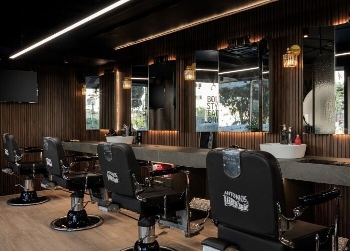 Interior of Antonio's Barbershop Spinola Park, San Ġiljan, MT with modern barber chairs and mirrors.