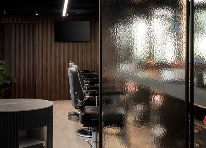 Sleek interior of Antonio's Barbershop Spinola Park, San Ġiljan, MT showcasing modern styling chairs and decor.