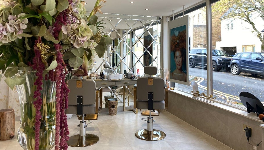 Elegant interior of Haylands Beauty Clinic in Buckhurst Hill, England, featuring stylish chairs and floral decor.