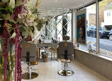 Elegant interior of Haylands Beauty Clinic in Buckhurst Hill, England, featuring stylish chairs and floral decor.