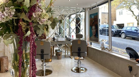 Elegant interior of Haylands Beauty Clinic in Buckhurst Hill, England, featuring stylish chairs and floral decor.