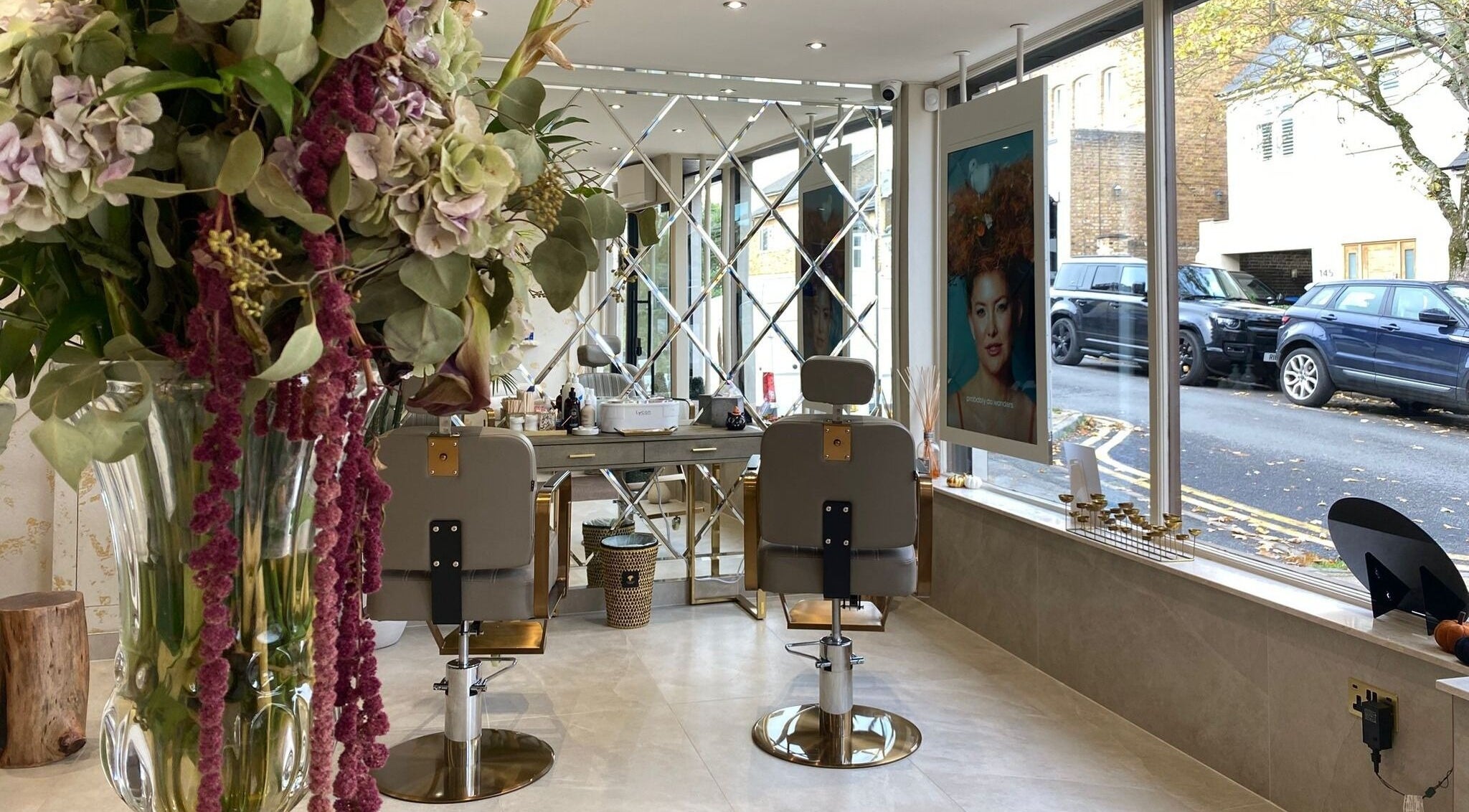 Elegant interior of Haylands Beauty Clinic in Buckhurst Hill, England, featuring stylish chairs and floral decor.