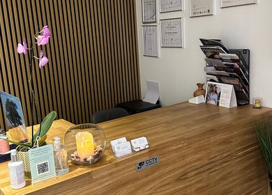 Reception desk at Sheffield Trichology Clinic and Head Spa, Sheffield, England, GB with brochures and purple orchid.