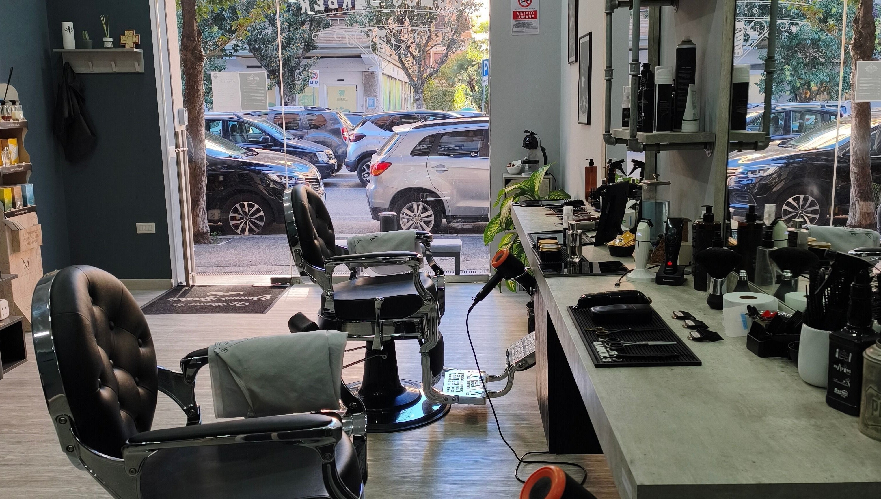 Interno moderno di Domus Barber Gregorio VII a Roma, Lazio, IT con sedie eleganti e attrezzature da barbiere.