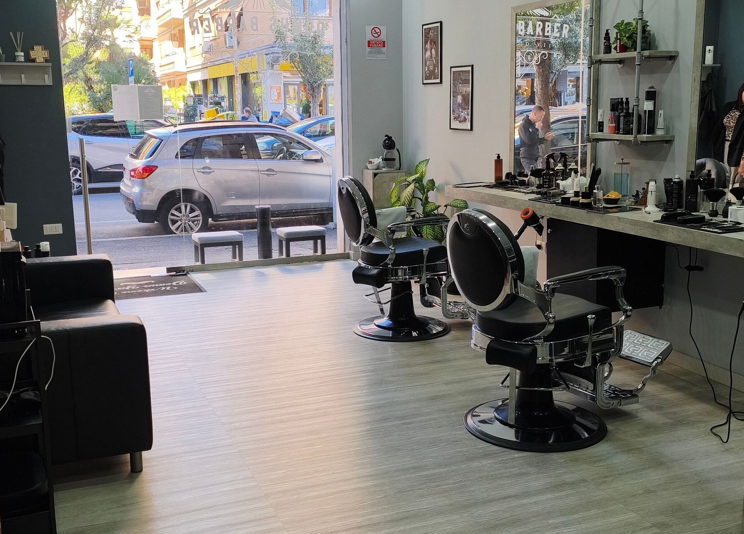 Interno di Domus Barber Gregorio VII a Roma, Lazio. Ambiente moderno e accogliente con sedie e specchi eleganti.
