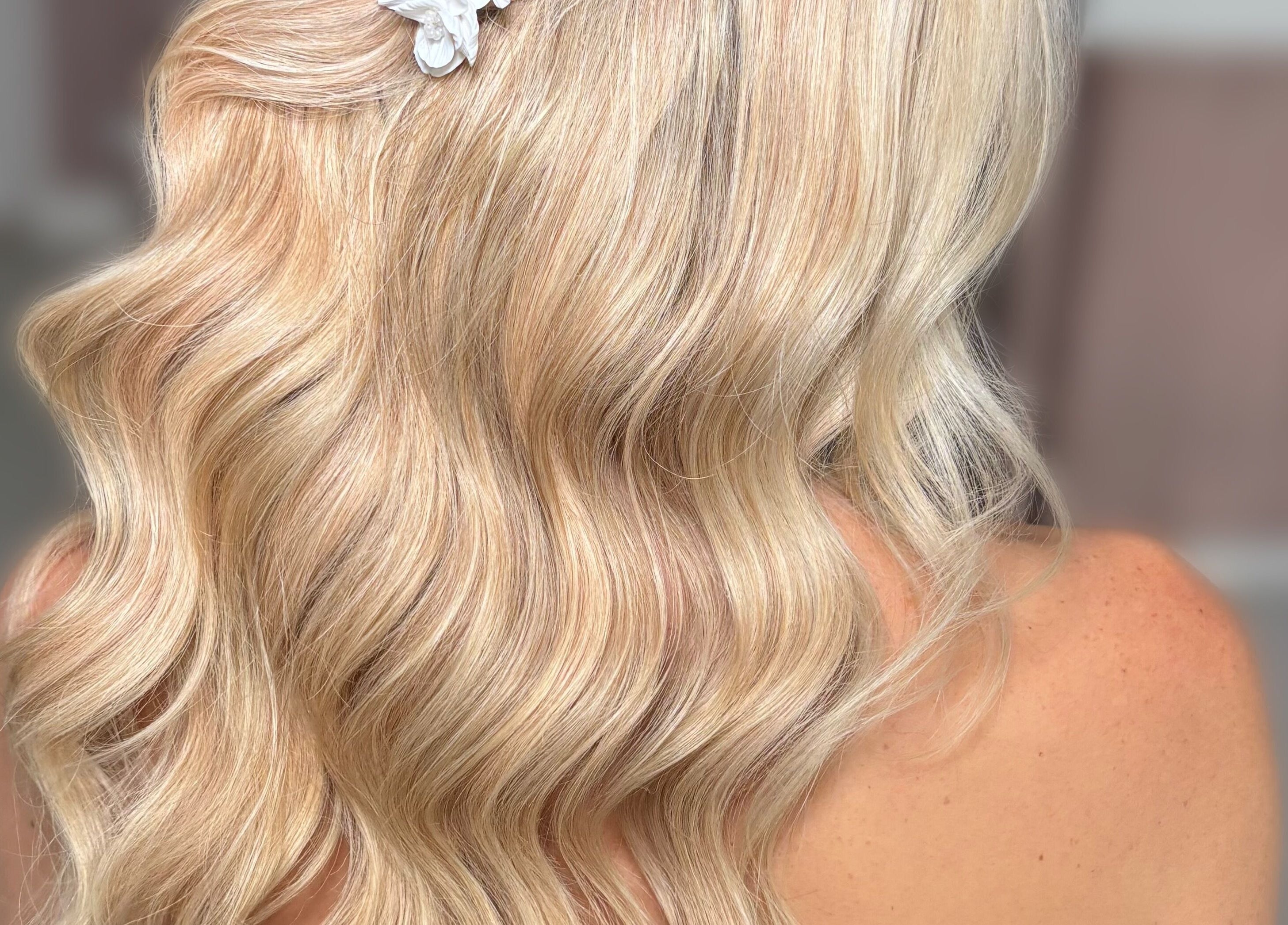 Elegant blonde hair with soft waves highlighted at Studio NK, Newbury, England, GB.