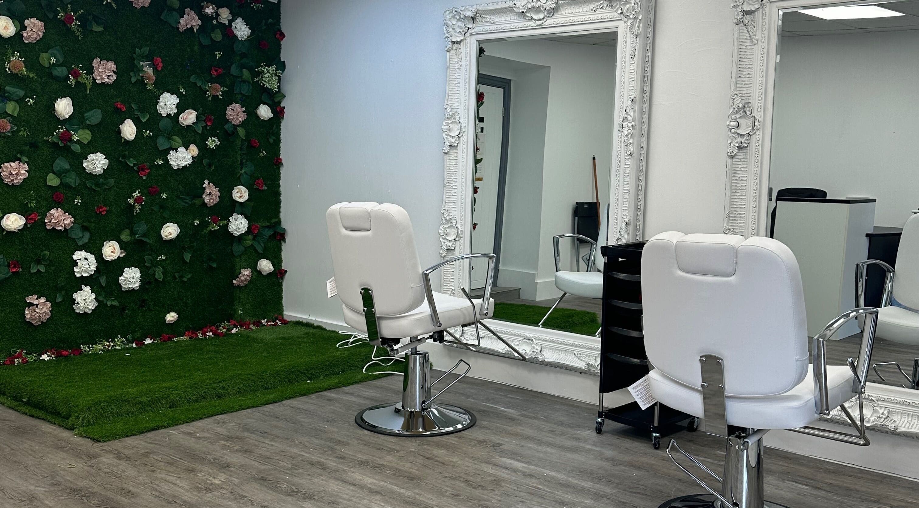 Elegant salon chair and mirror at Posh Academy, ASHTON-UNDER-LYNE, GB with floral wall decor.