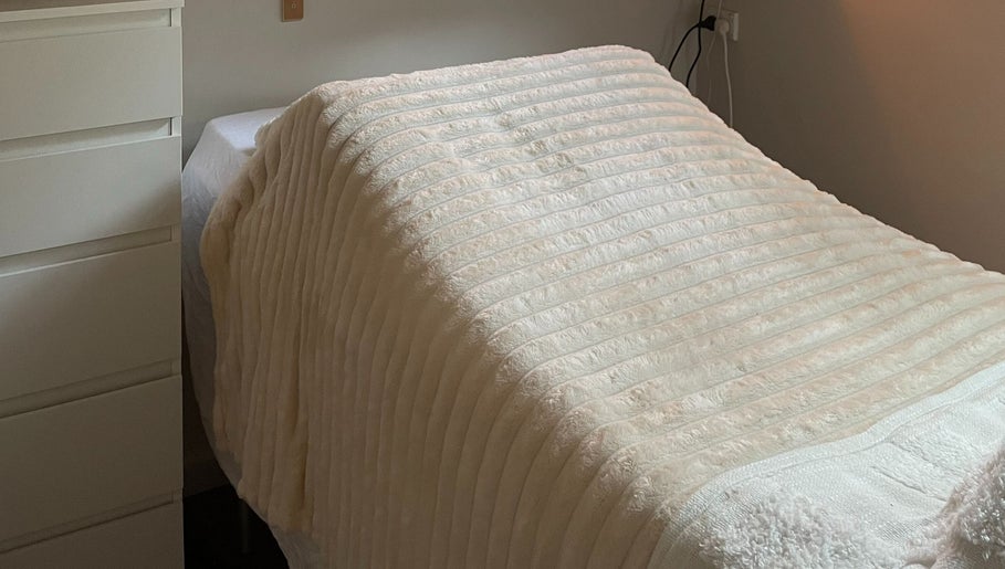 Relaxing treatment room at Georgia Grace Beauty in Berry, New South Wales, AU, with a cozy massage table.