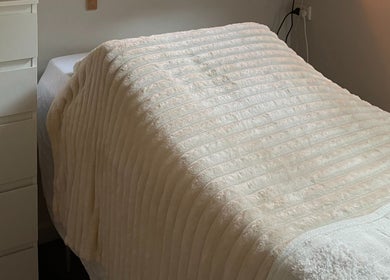 Relaxing treatment room at Georgia Grace Beauty in Berry, New South Wales, AU, with a cozy massage table.