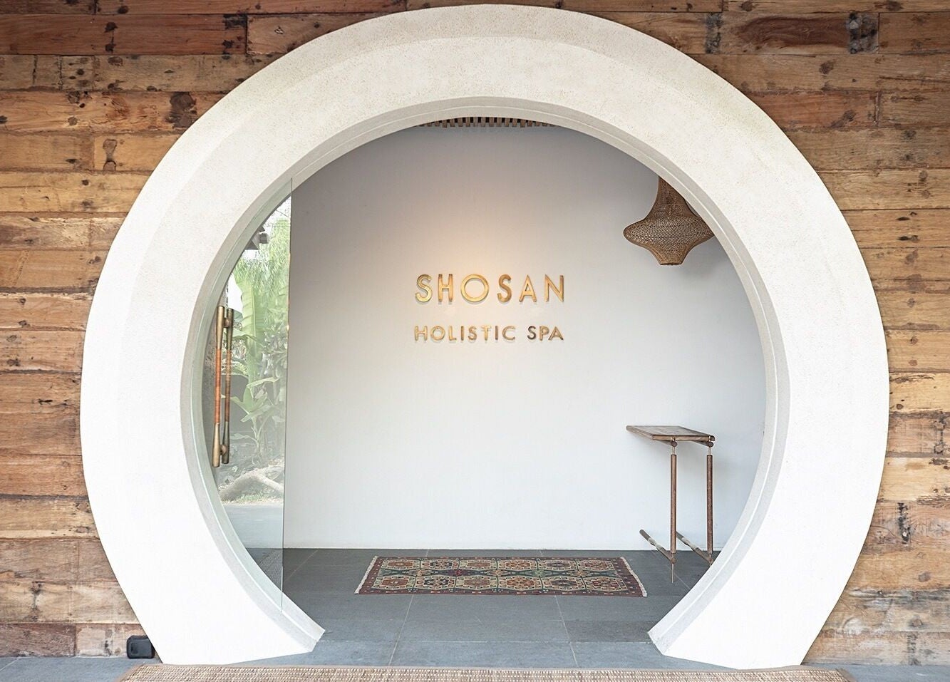 Elegant entrance of Shosan Holistic Spa in Bali, Bali, ID, featuring rustic wood and modern design.