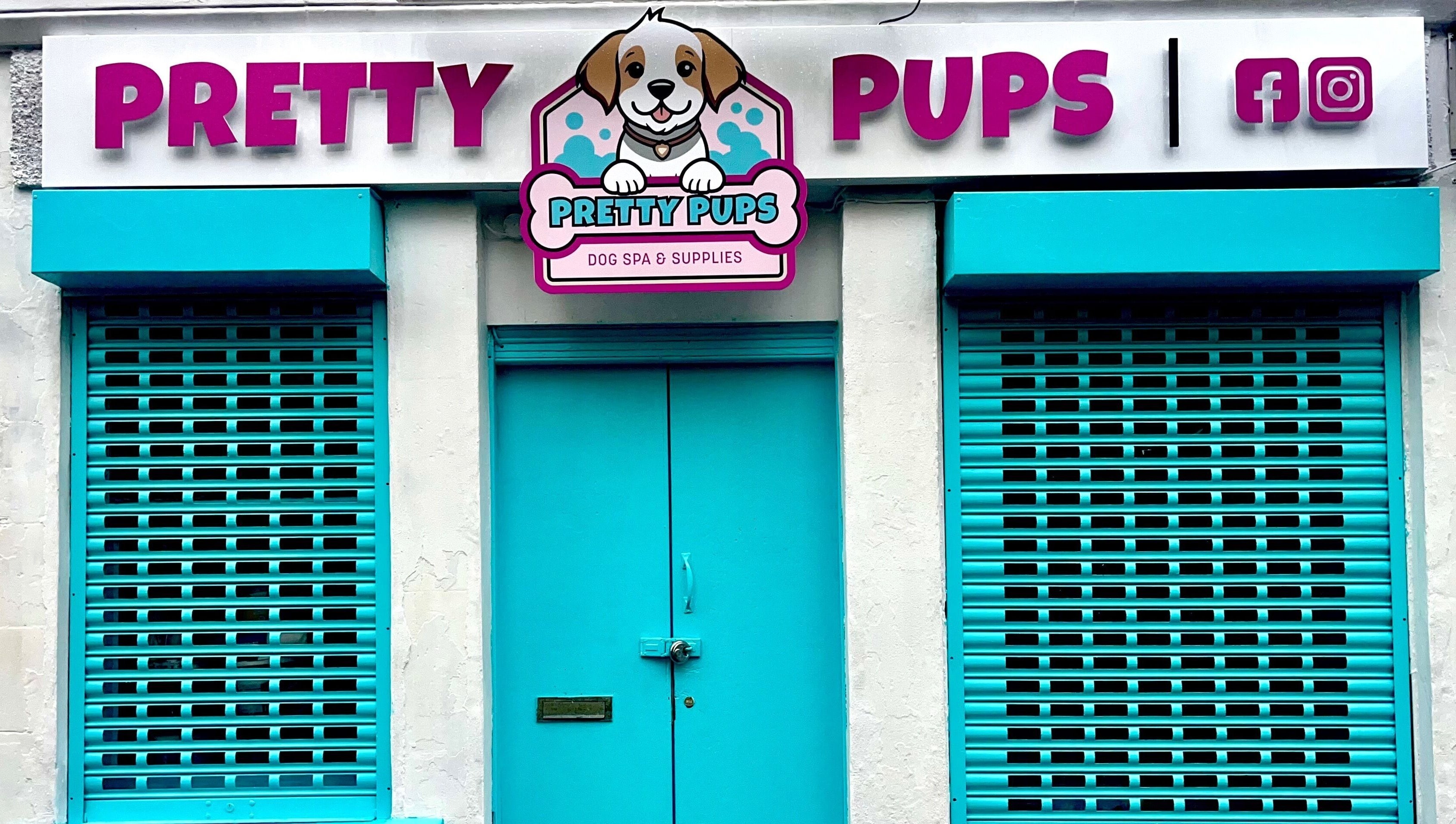 Pretty Pups Dog Spa entrance with bright teal shutters in Gourock, Scotland, GB.