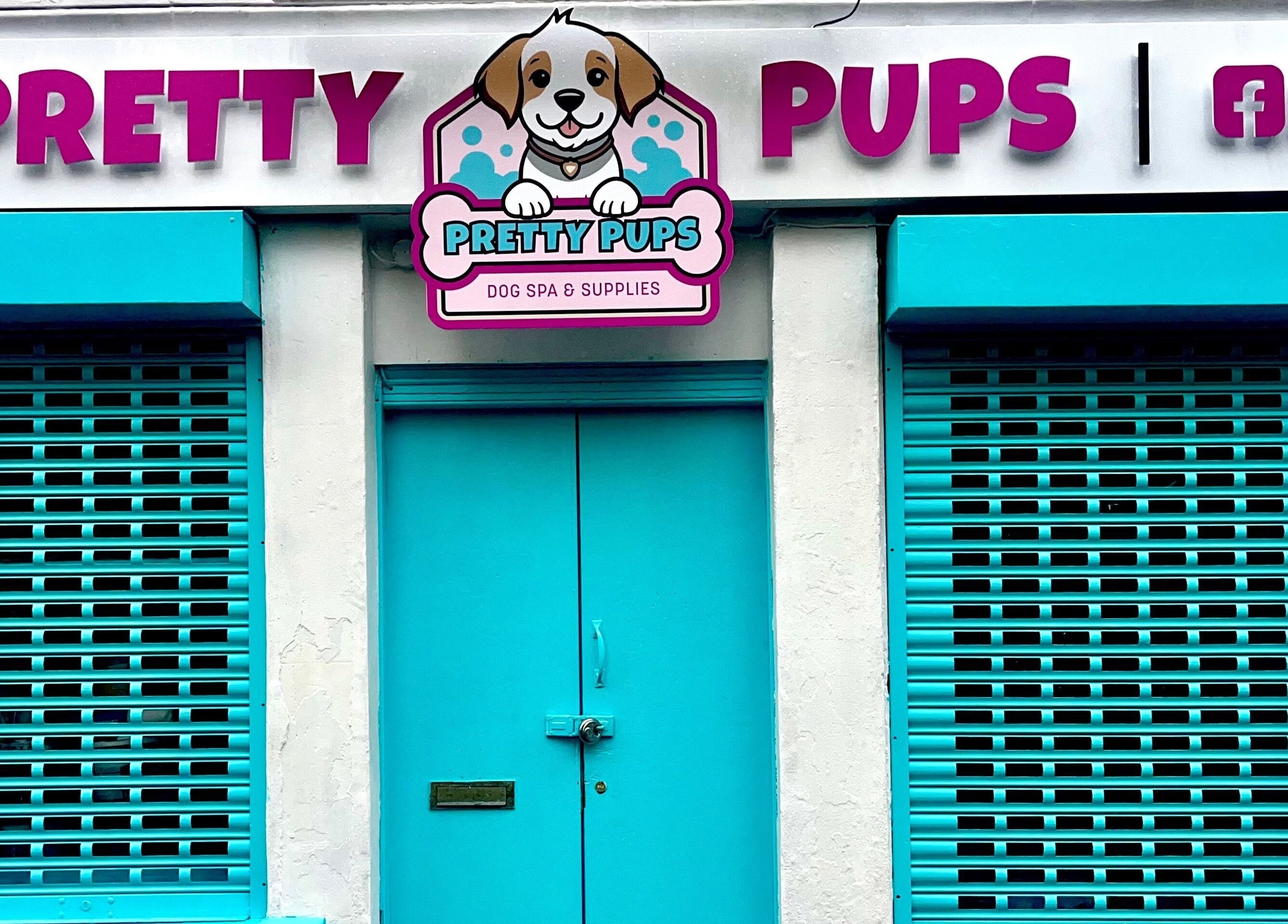 Pretty Pups Dog Spa entrance with bright teal shutters in Gourock, Scotland, GB.
