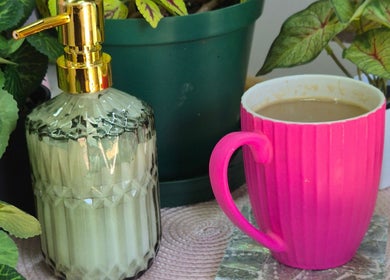 Radiant Blossom - Pretoria North: Pink mug and soap dispenser amidst lush plants, Pretoria, Gauteng, ZA.