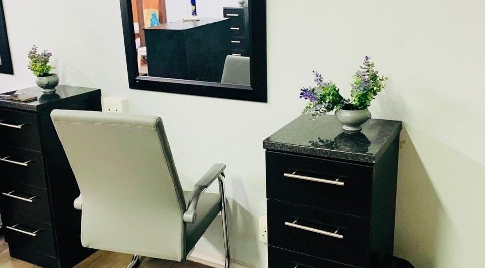 Modern salon chair and dresser at Entlestylist, East London, Eastern Cape, ZA. Sleek design with decorative plants.