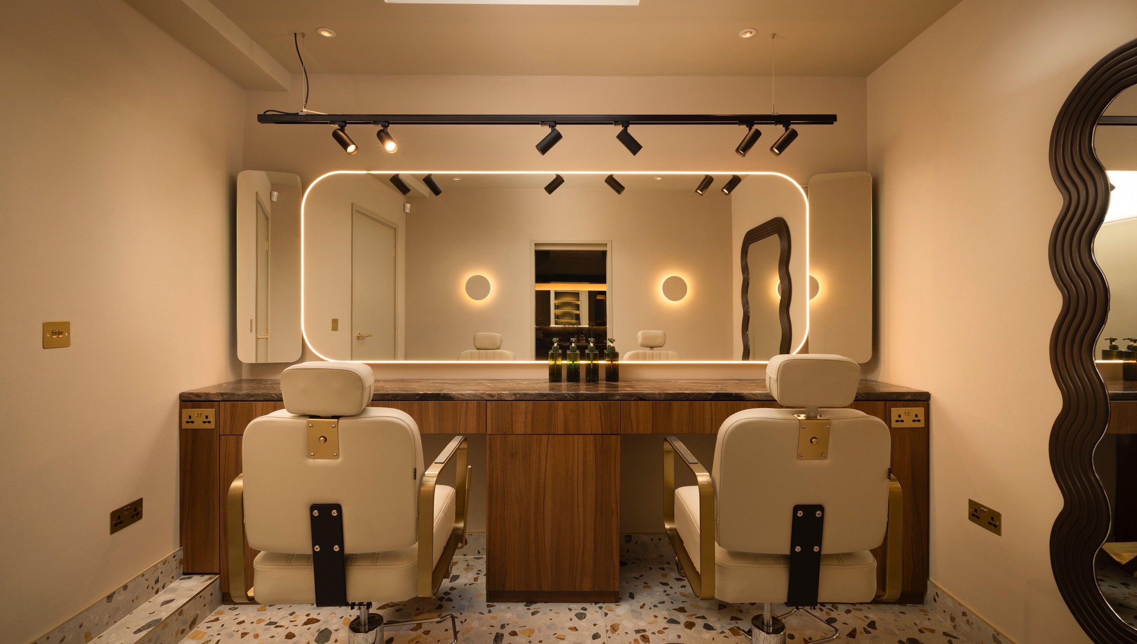About YU salon interior with chic mirrors and plush chairs in London, England, GB.