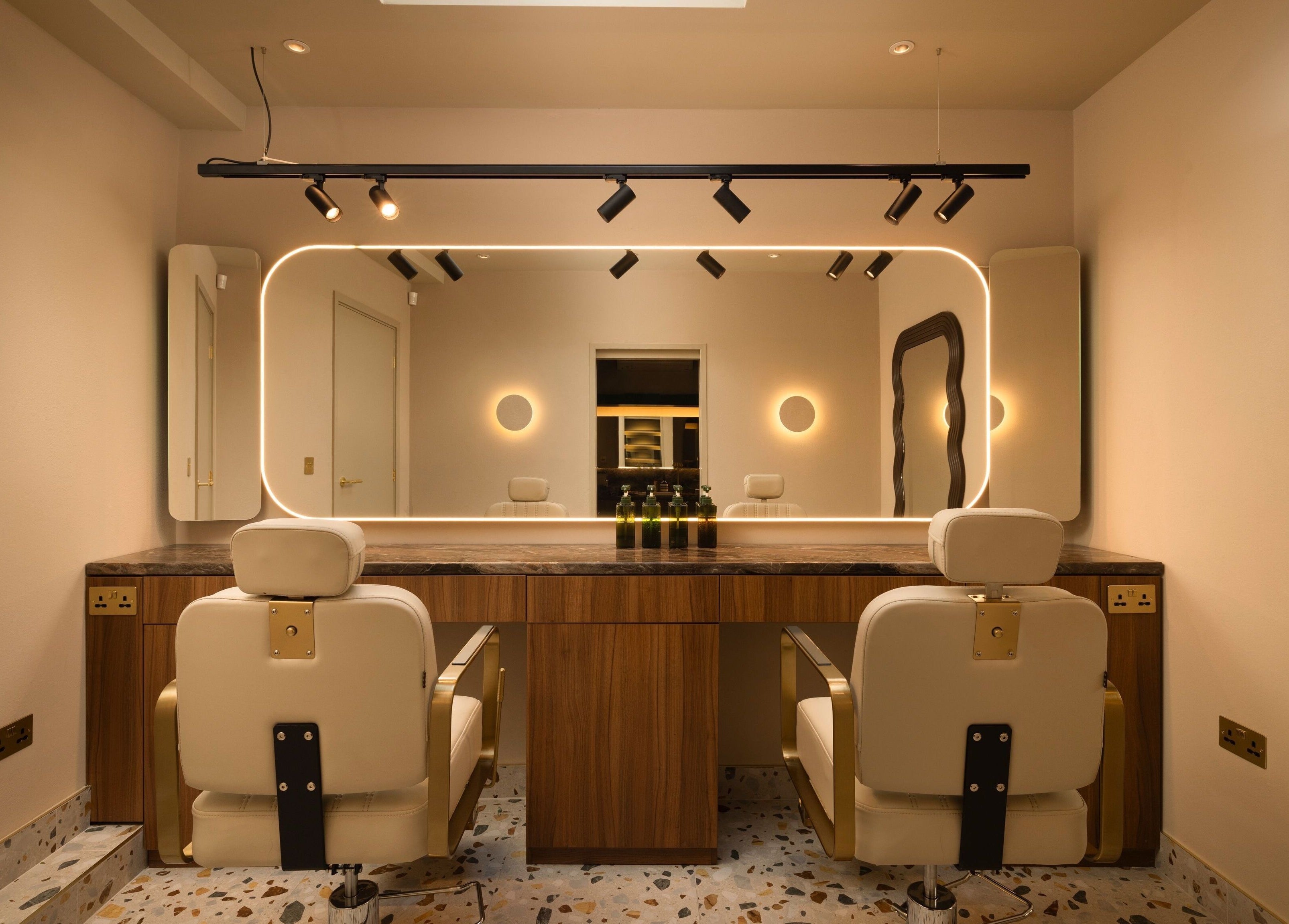 About YU salon interior with chic mirrors and plush chairs in London, England, GB.