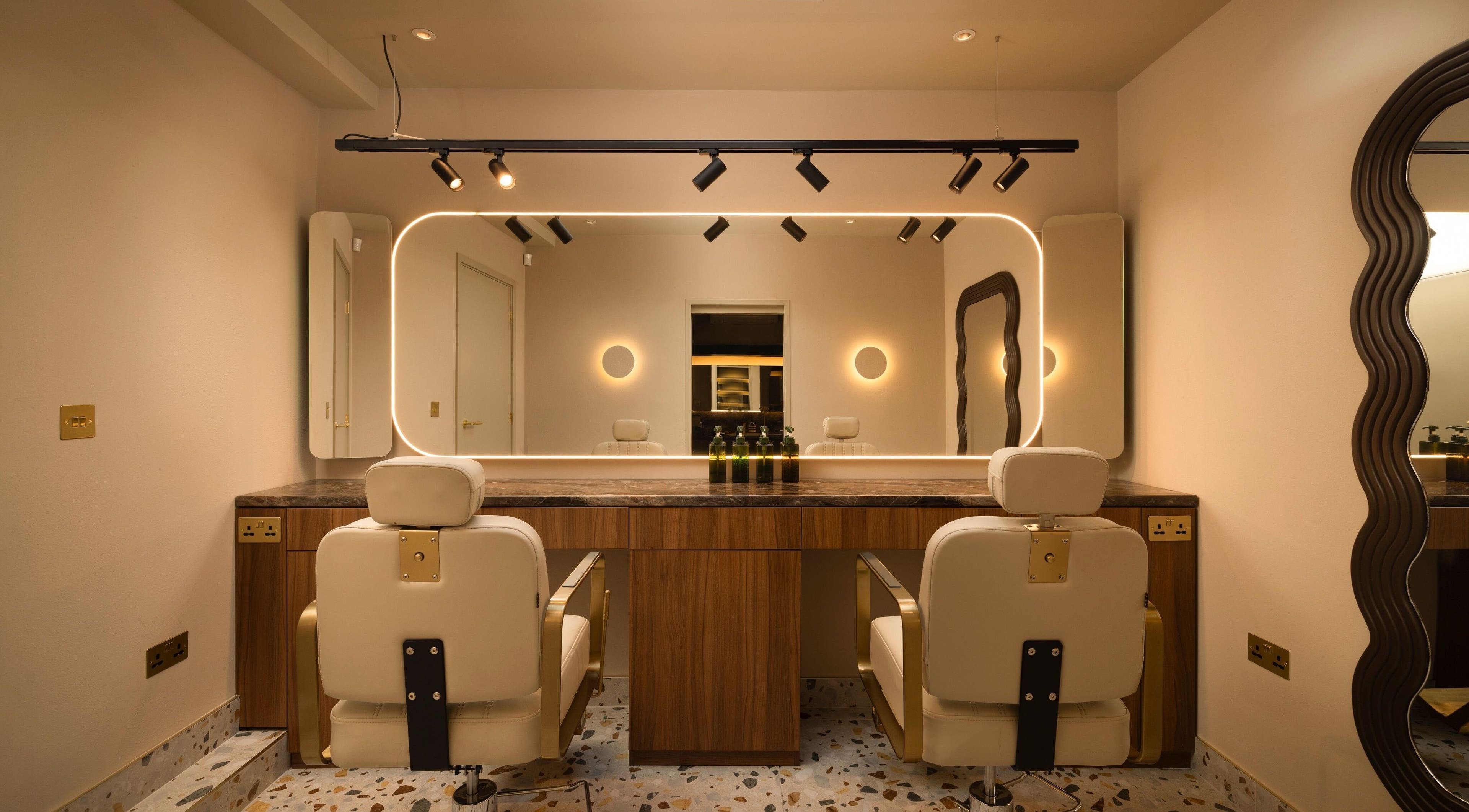 About YU salon interior with chic mirrors and plush chairs in London, England, GB.