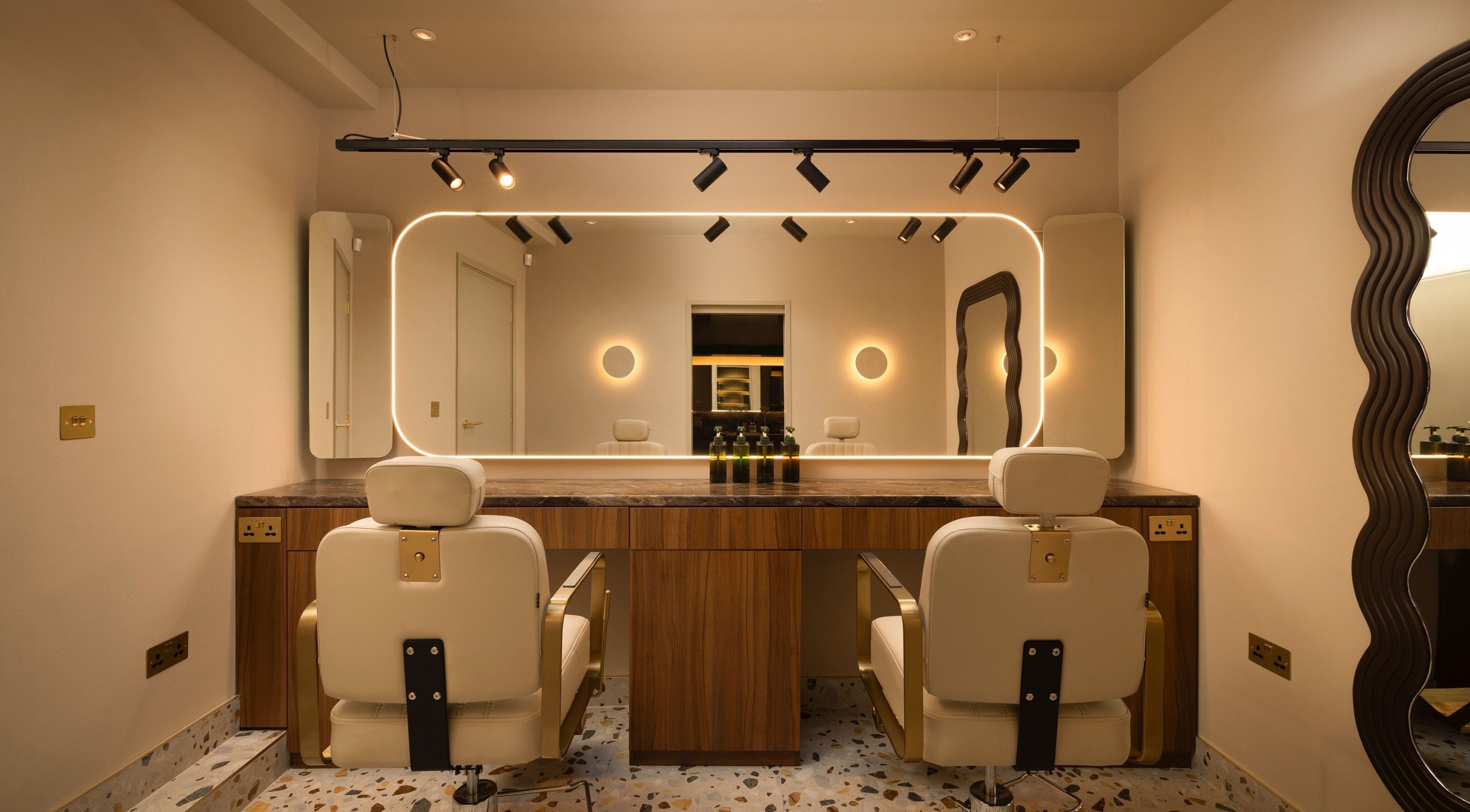 About YU salon interior with chic mirrors and plush chairs in London, England, GB.