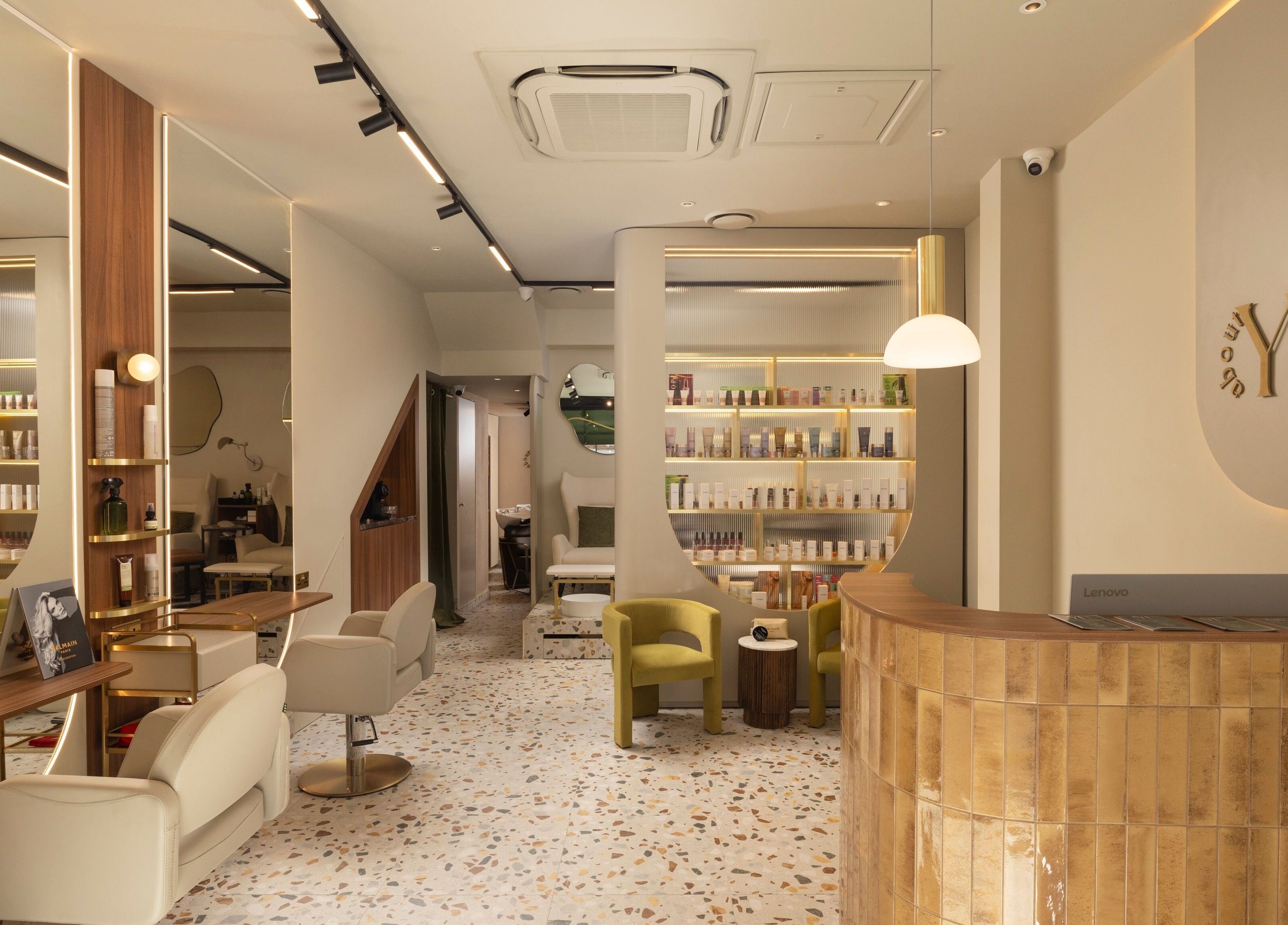 Chic interior of About YU salon in London, England, GB, featuring stylish seating and product displays.