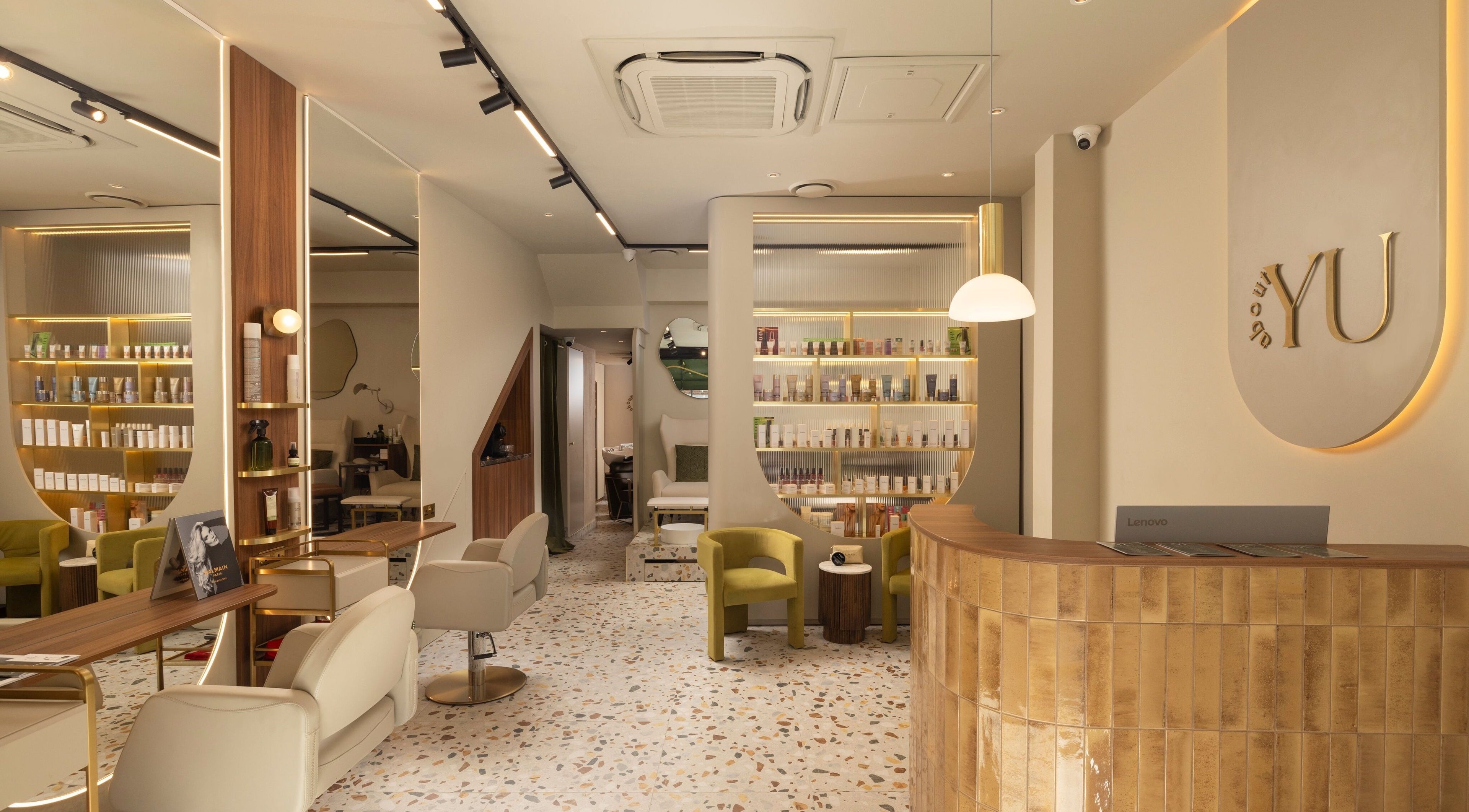 Chic interior of About YU salon in London, England, GB, featuring stylish seating and product displays.