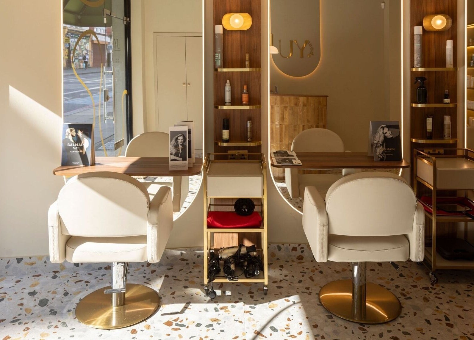 Elegant salon chairs and styling stations at About YU, located in London, England, GB, showcasing modern decor.