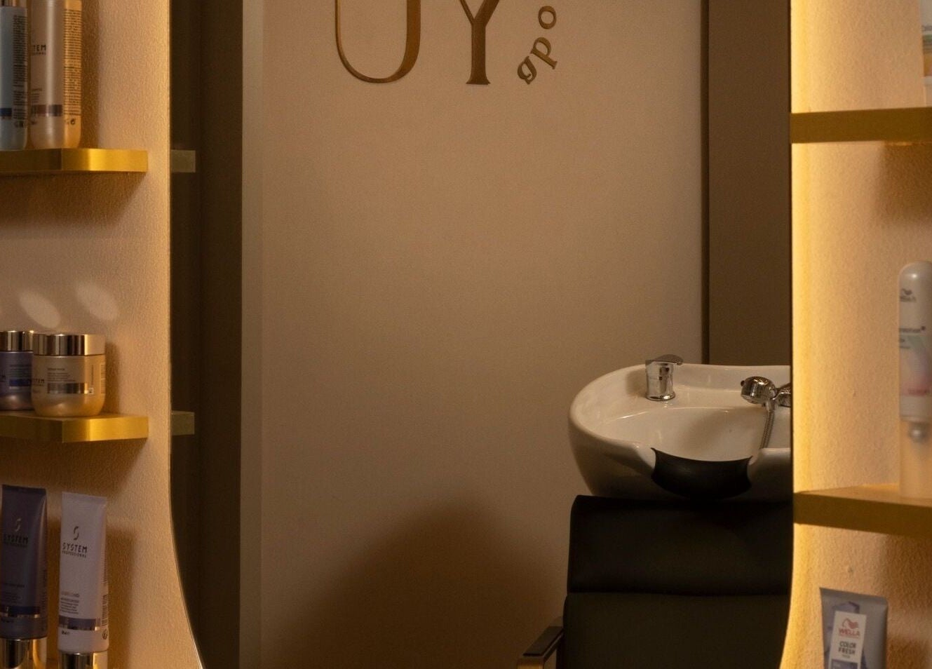 Elegant shelves with beauty products at About YU salon, London, England, GB, showcasing a serene spa atmosphere.