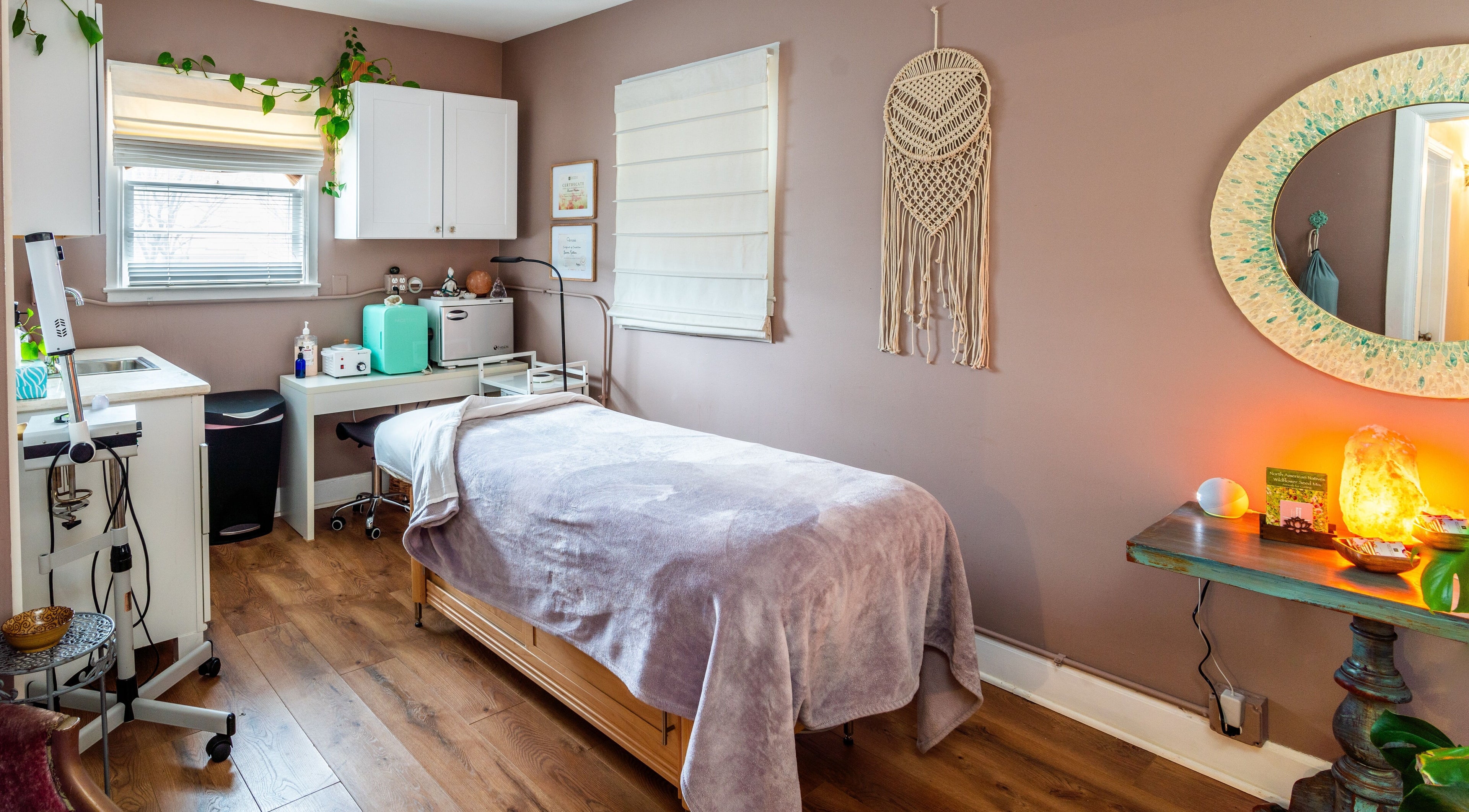 A calming treatment room at About Face Organic Skincare Studio in Lexington, Kentucky, US with a cozy spa bed.