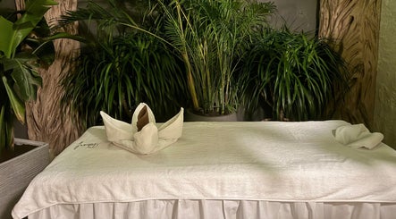 Relaxing massage table setup at Pious Therapy Center L.L.C, دبي, دبي, AE surrounded by lush greenery.