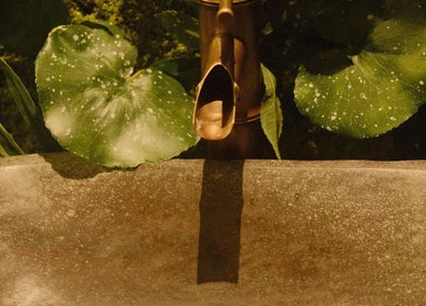 Elegant bamboo fountain surrounded by lush greenery at Pious Therapy Center L.L.C, دبي, دبي, AE.