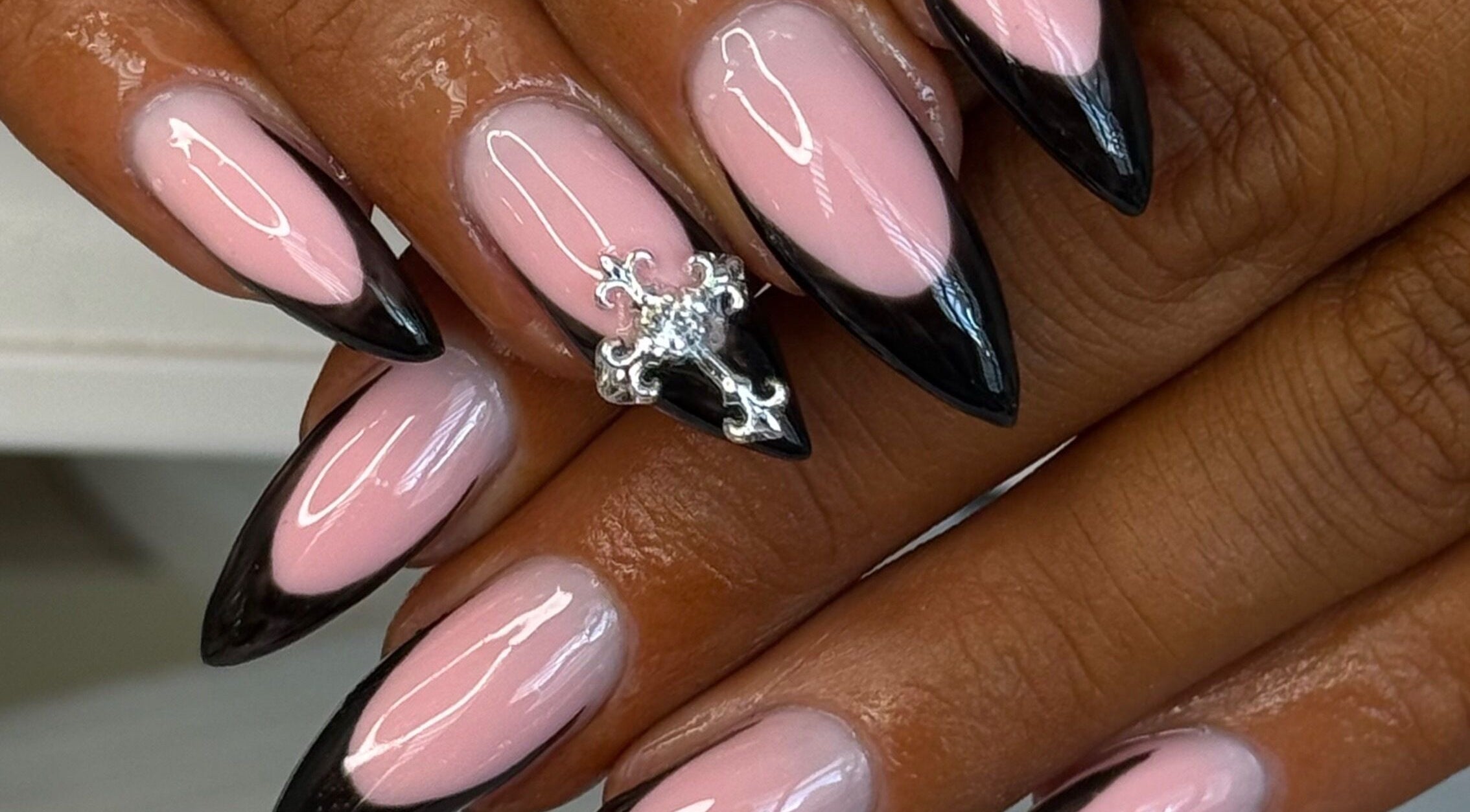 Chic black-tipped nails with charm at Rcbeautyparlour, Dublin, County Dublin, IE.