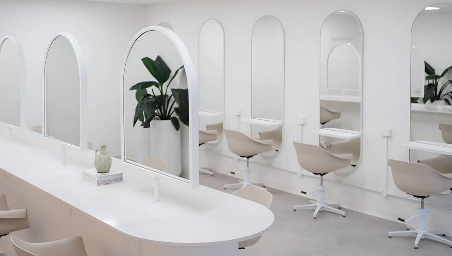 Chic salon interior at Indie Mane, Raymond Terrace, NSW. Minimalist mirrors and styling stations in a sleek setting.