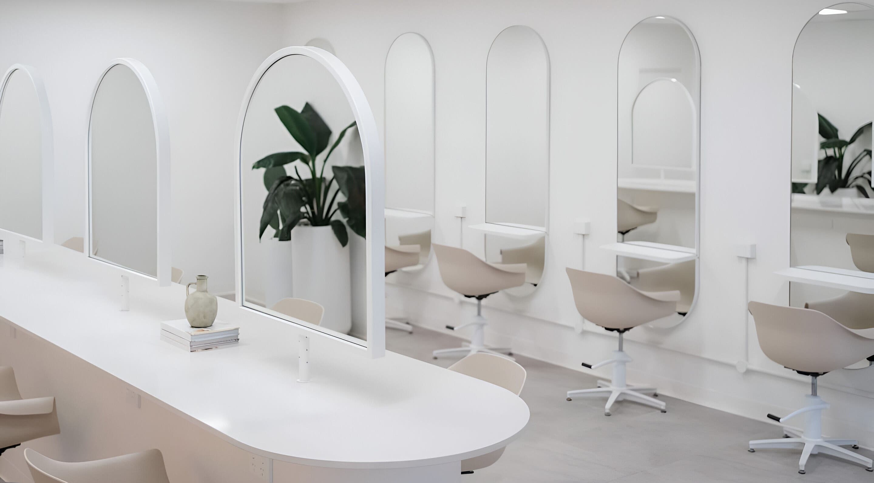 Chic salon interior at Indie Mane, Raymond Terrace, NSW. Minimalist mirrors and styling stations in a sleek setting.