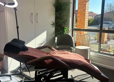 Cozy treatment room at MKL Beauty in Gungahlin, Australian Capital Territory, AU, with a plush chair and modern decor.