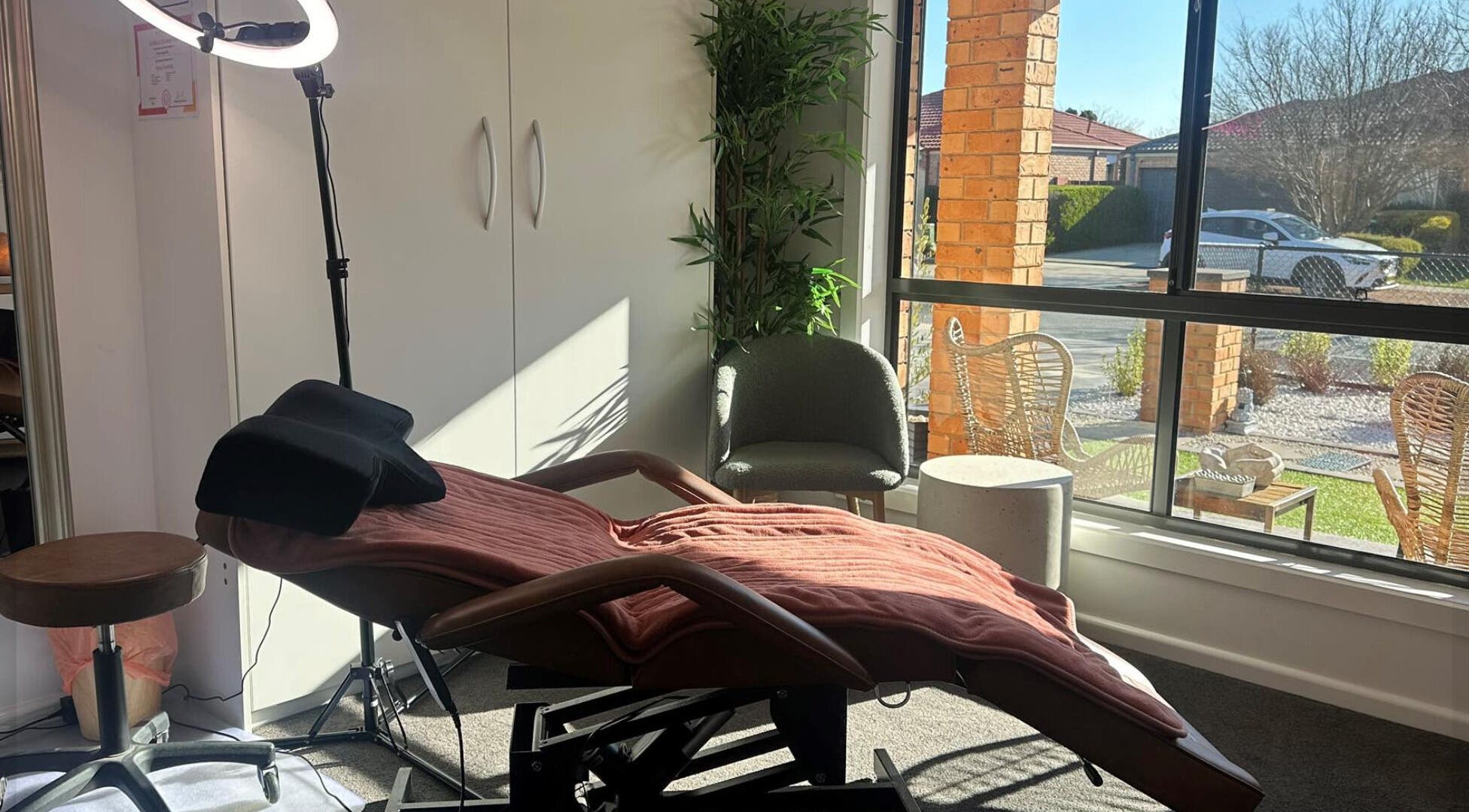 Cozy treatment room at MKL Beauty in Gungahlin, Australian Capital Territory, AU, with a plush chair and modern decor.