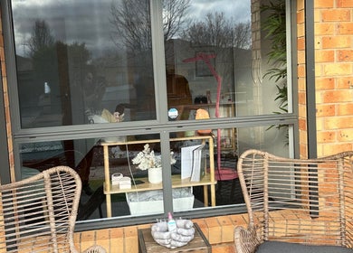 Relaxing patio at MKL Beauty, Gungahlin, Australian Capital Territory, AU, with wicker chairs and a window view.