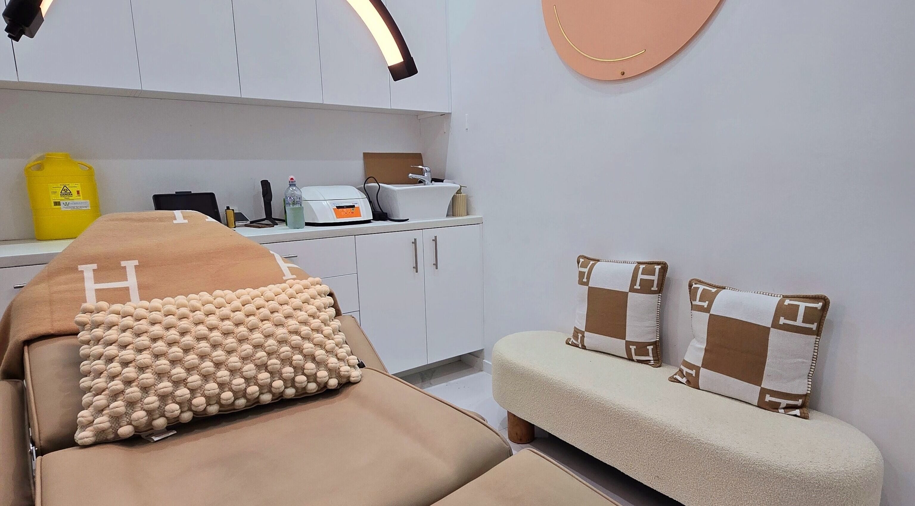 Relaxing treatment room at Rm Aesthetics, Berala, New South Wales, AU, featuring cozy seating and spa bed.